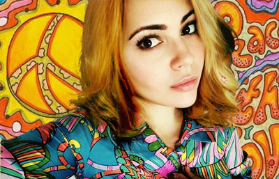 Woman in a 1960s psychedelic maximalist fashion dress from Trash Vintage UK