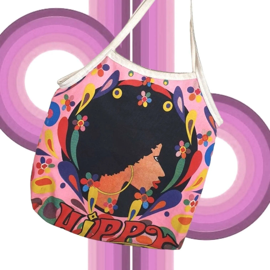 Colorful vintage shoulder bag with a stylized face design and 'QUIPPY' text on a pink background.