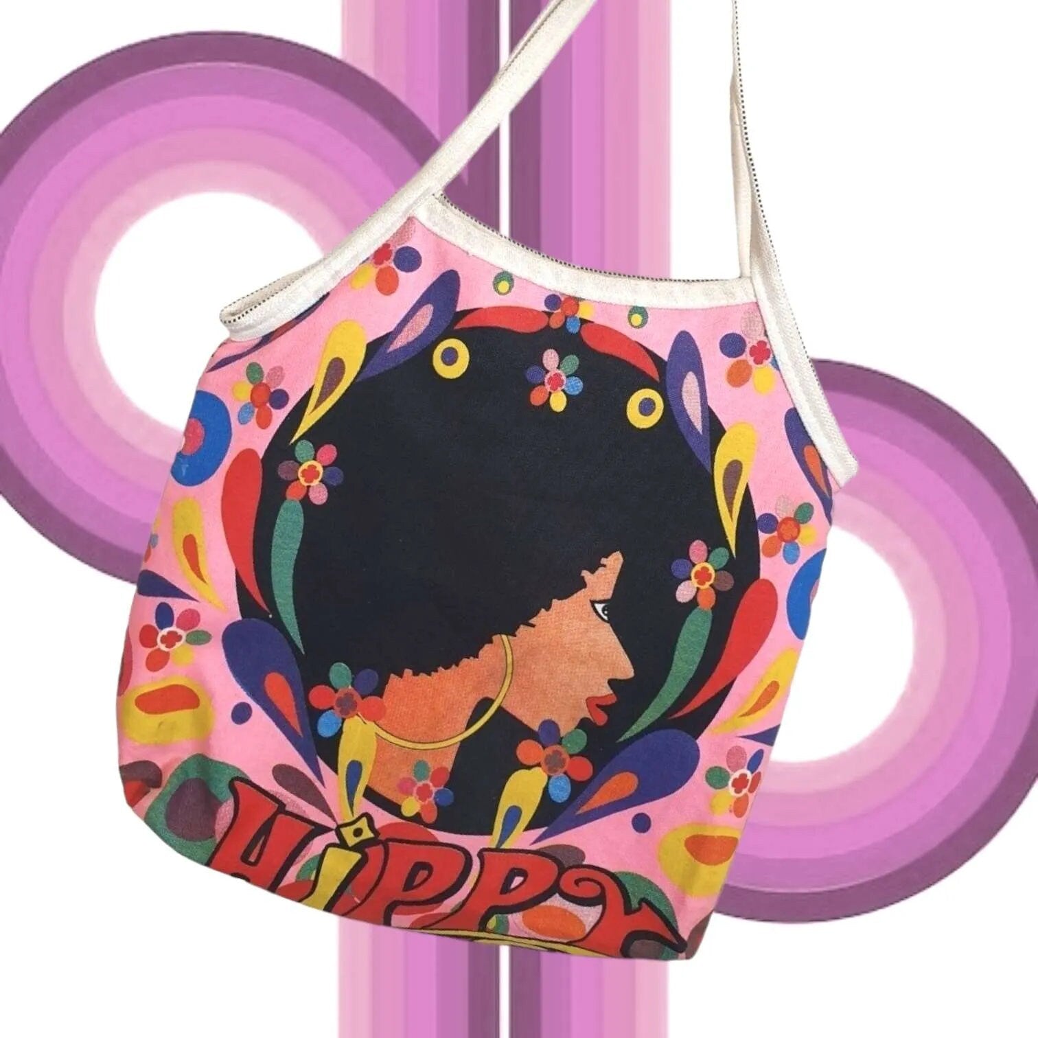 Colorful vintage shoulder bag with a stylized face design and 'QUIPPY' text on a pink background.