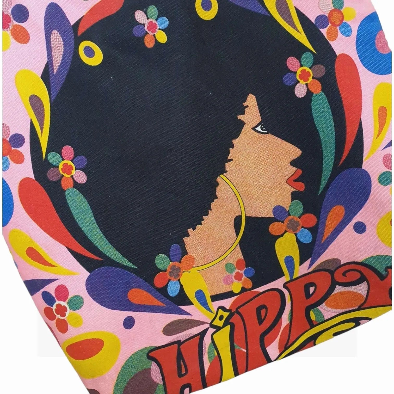 Colorful vintage handbag with an omage of a girl with afro and floral designs, featuring the word Hippy