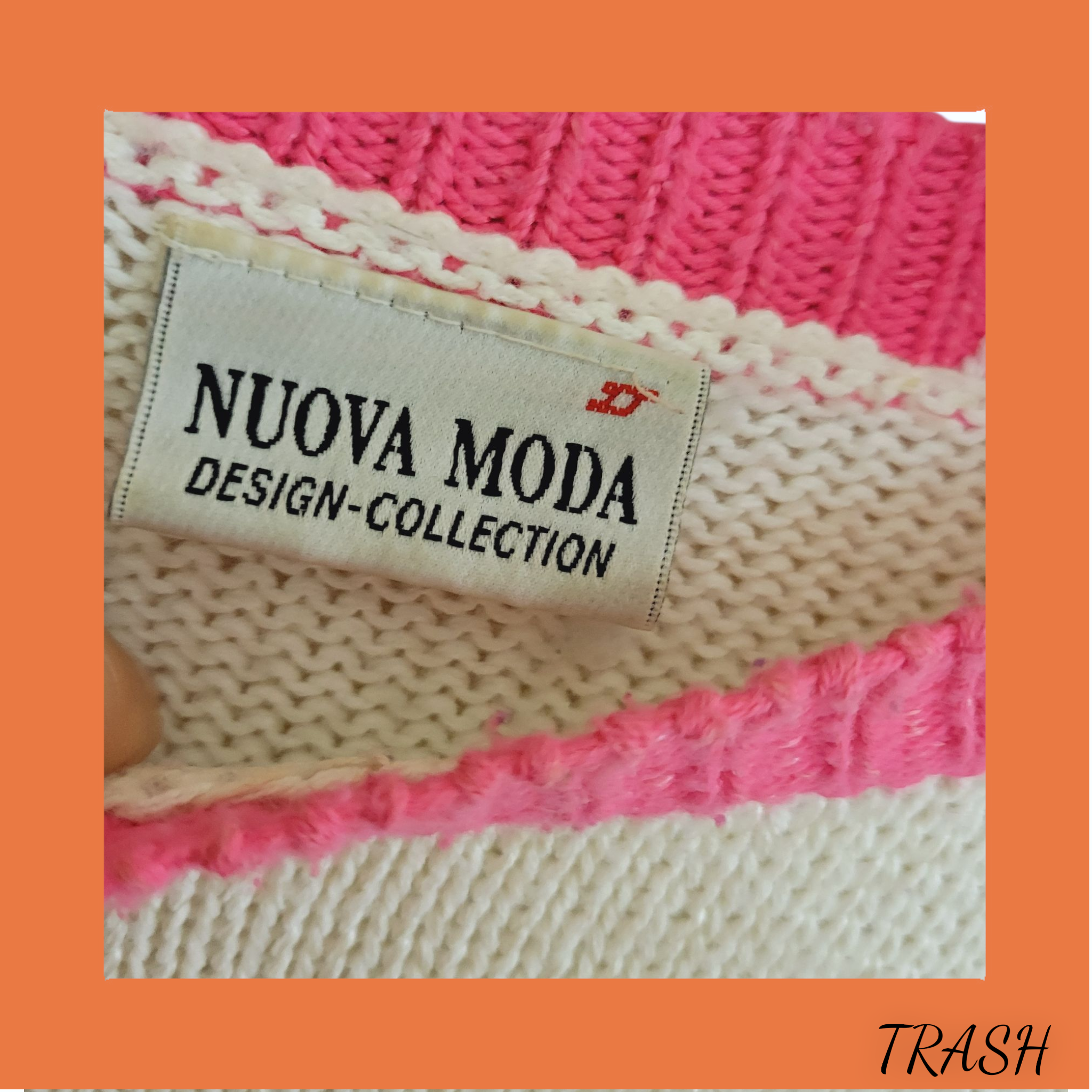 Close-up of a 'Nuova Moda Design Collection' label on a knitted fabric with pink and beige colors.