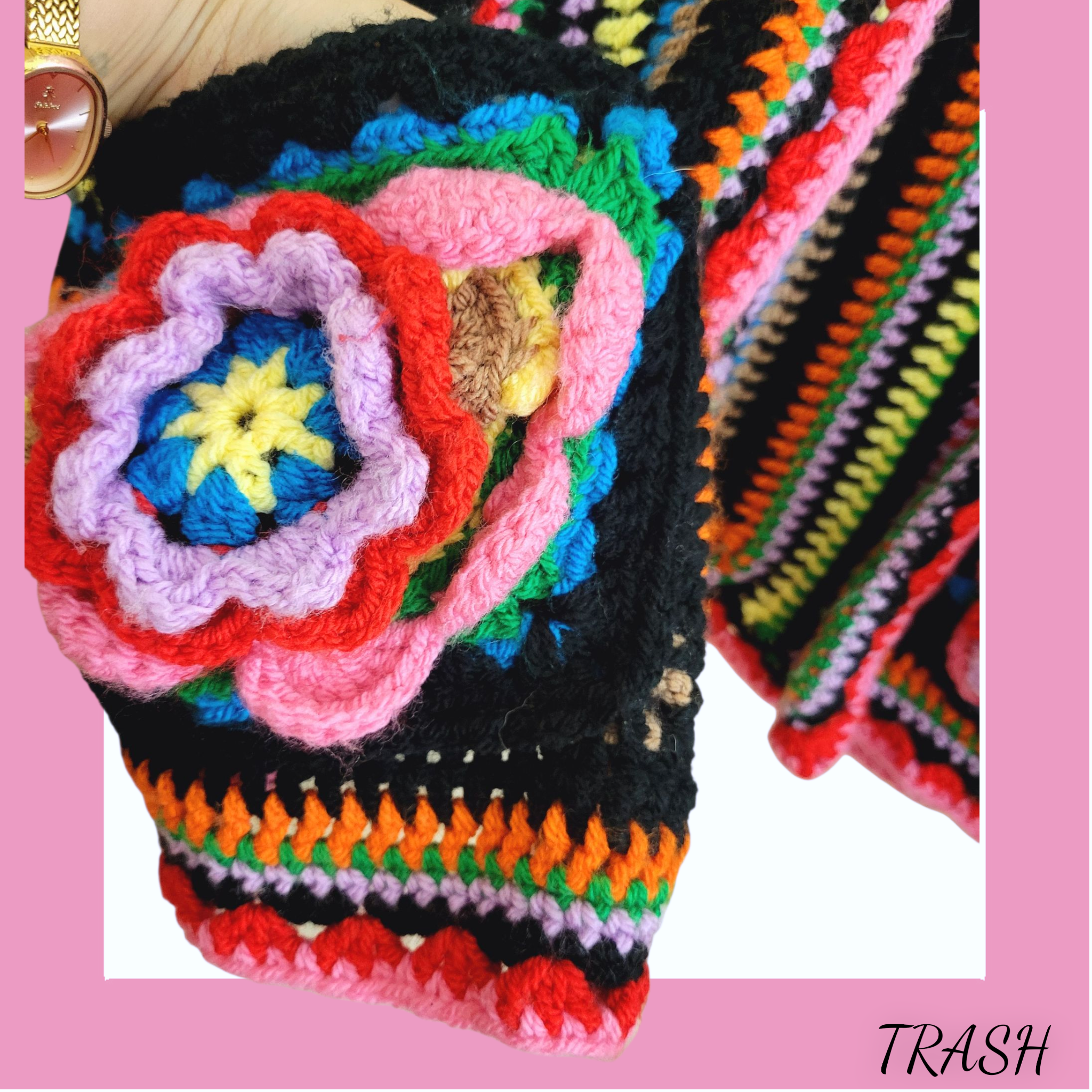 Colorful crocheted flower on pocket of vintage cardigan