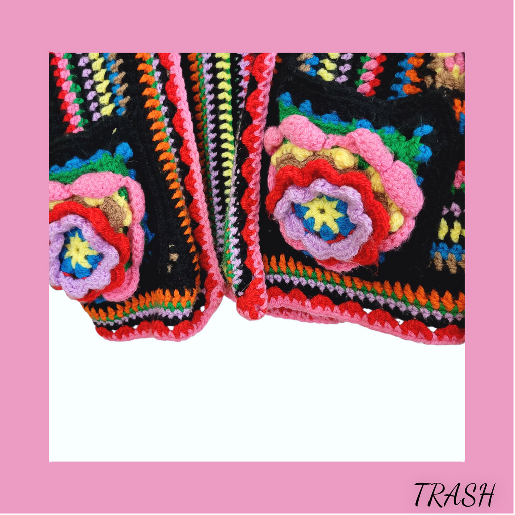 Pocket view of a Unique handmade boho cardigan jacket with rainbow knit design and floral pcokets