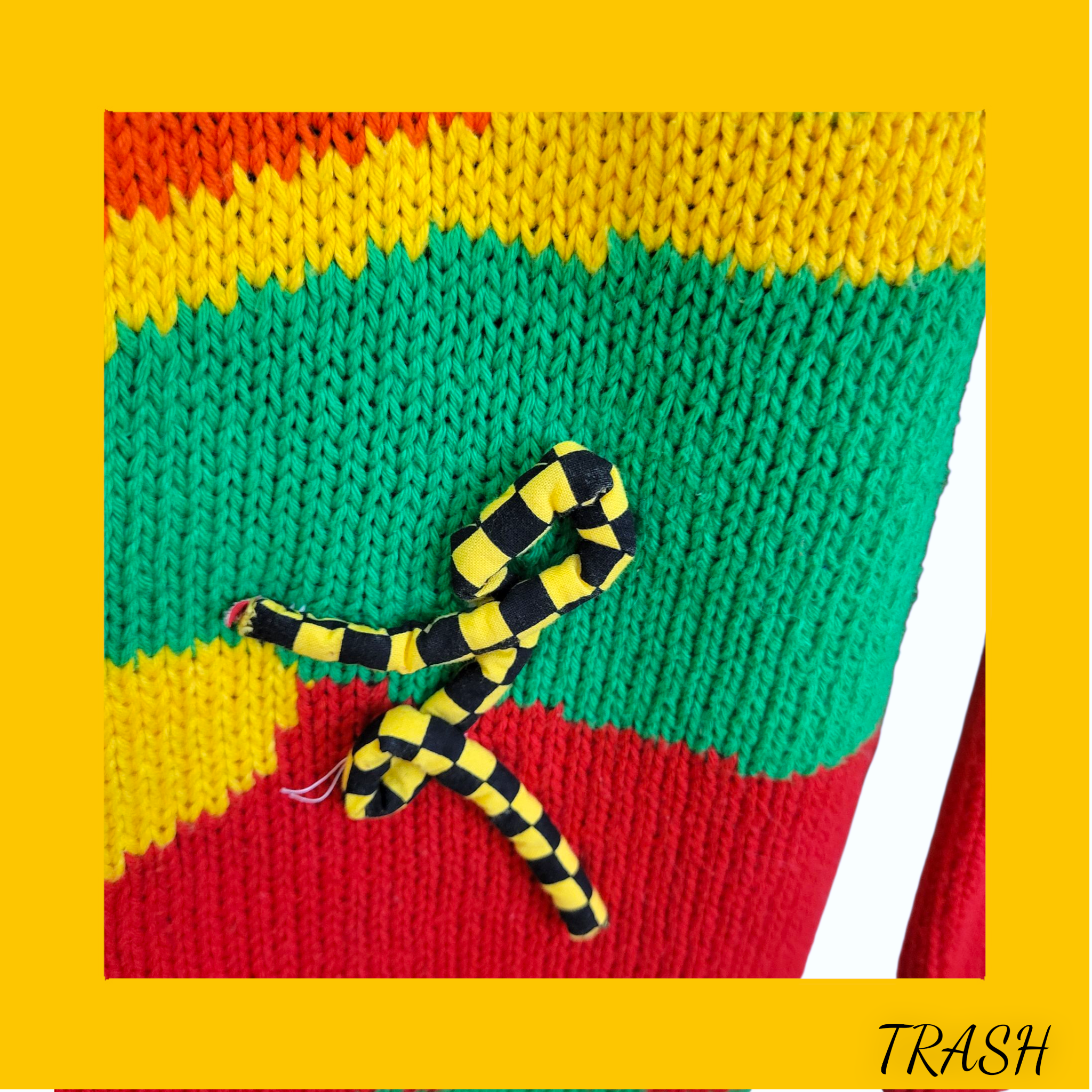 Colorful knitted fabric with a snake design on a yellow background