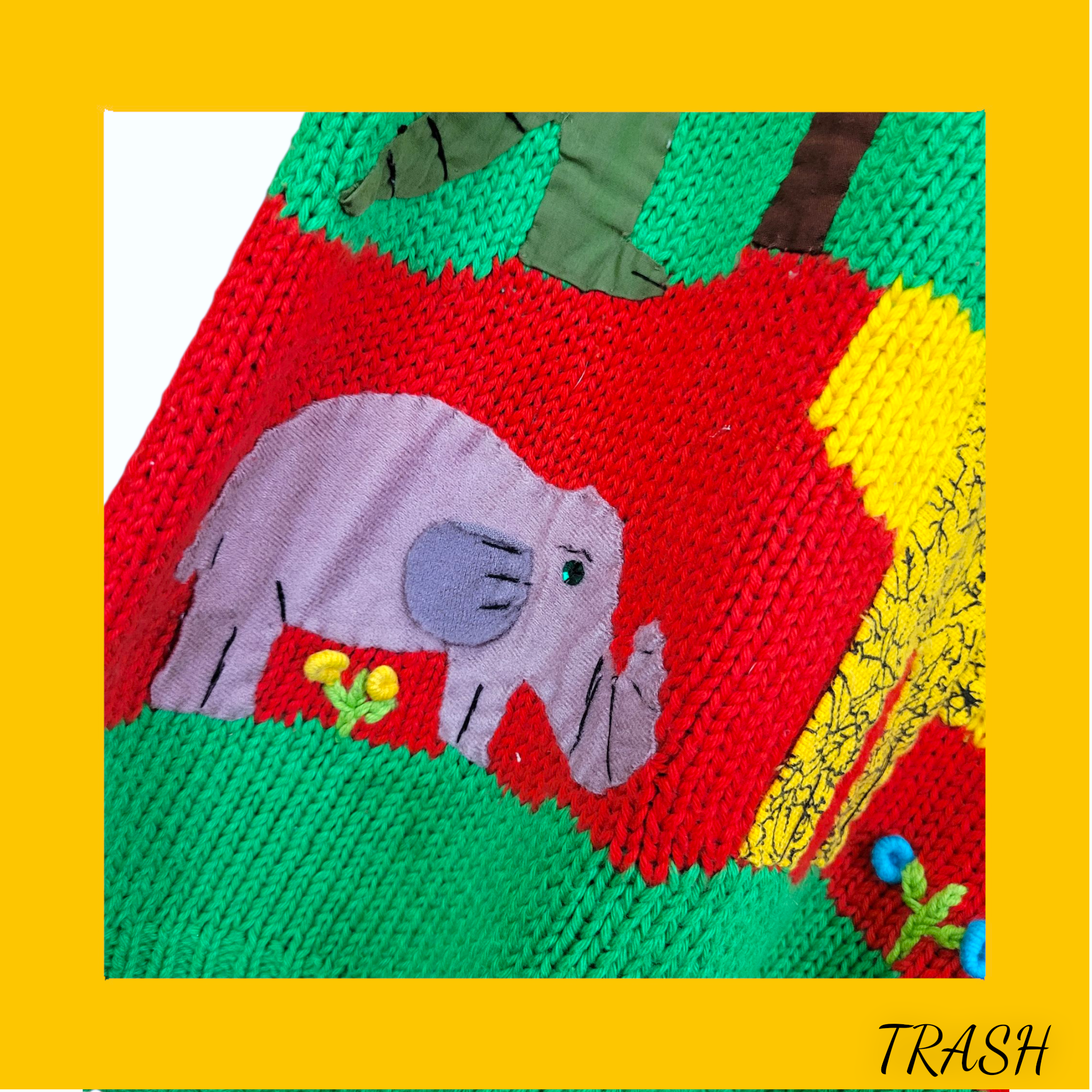 Colorful knitted jumper with an elephant design on a yellow border