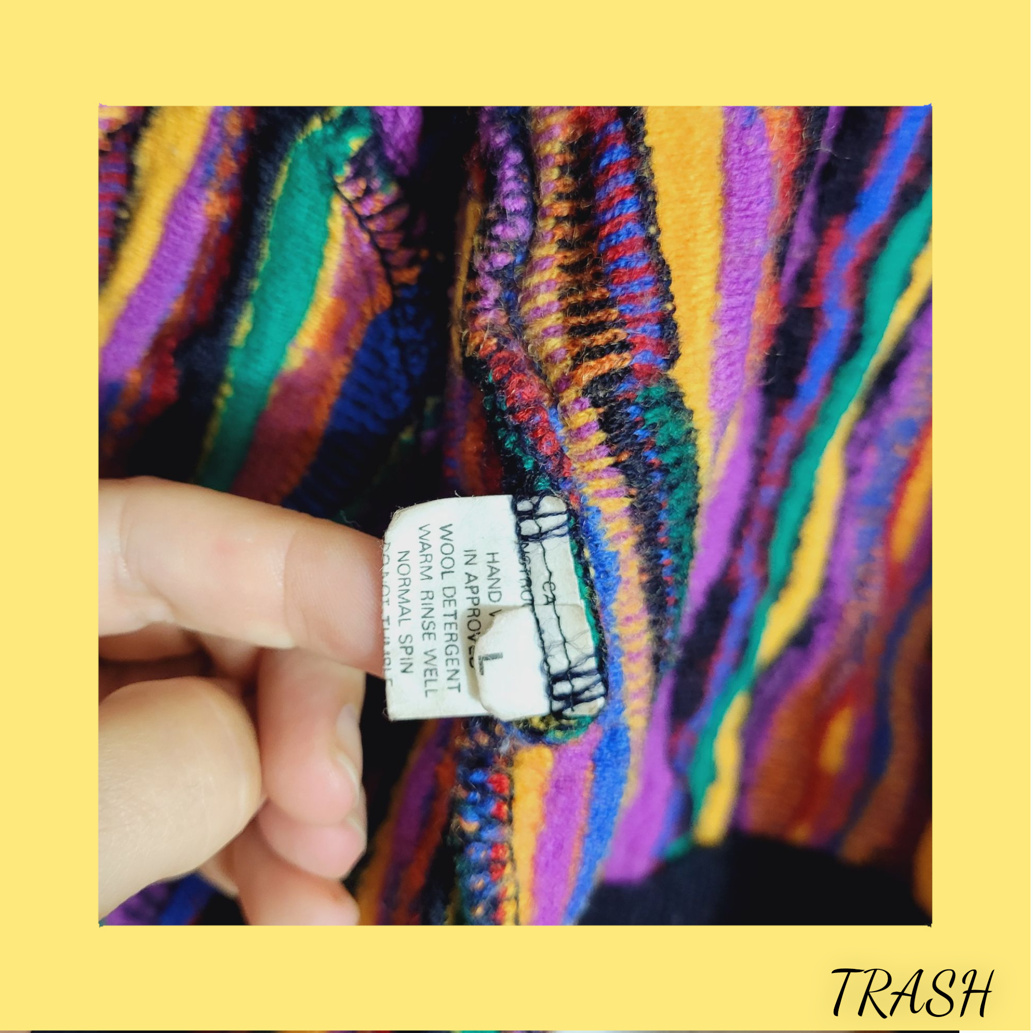 Colorful fabric with a label held by a hand on a yellow border, labeled 'TRASH'.