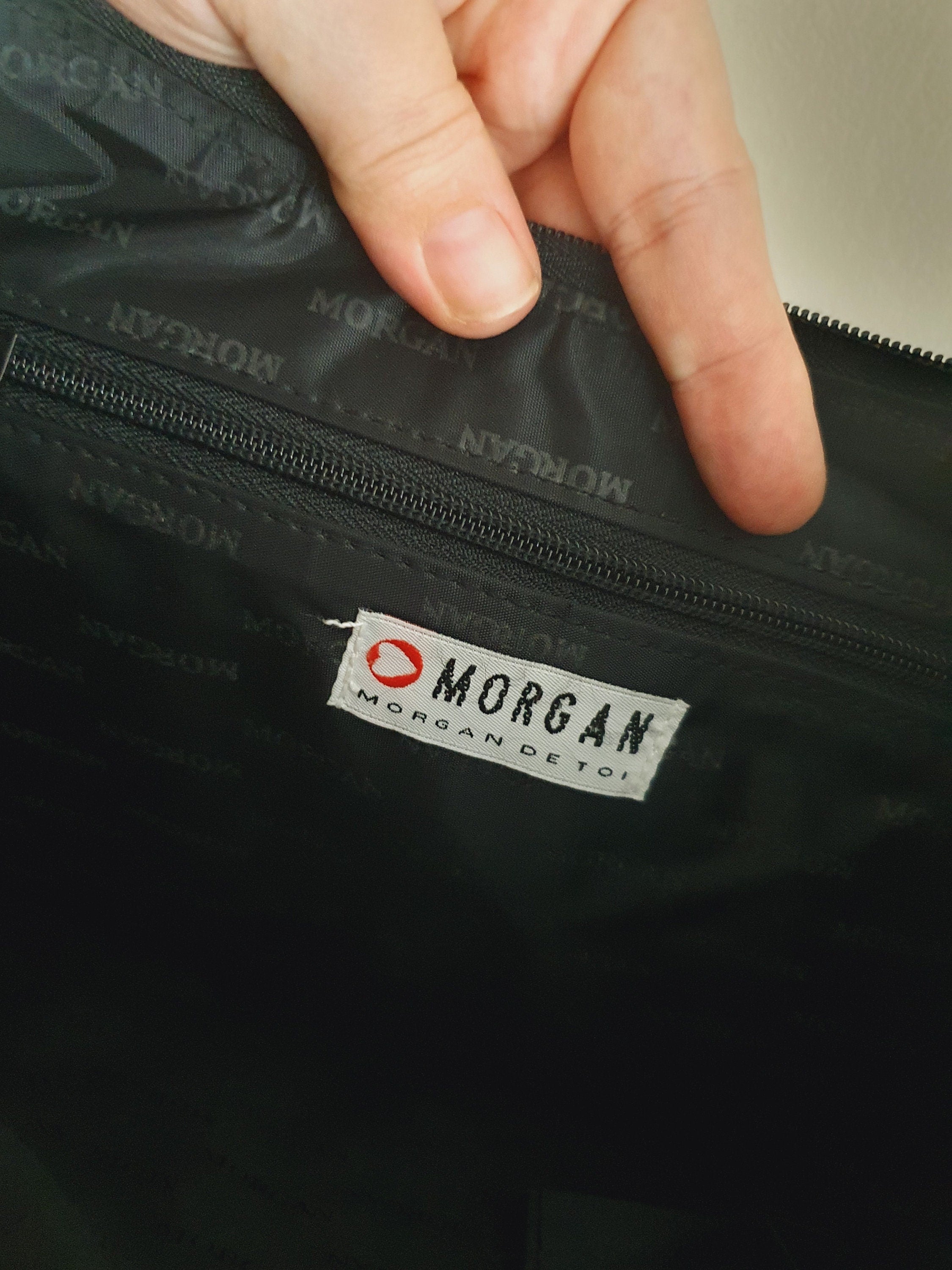 Interior of vintage Morgan De Toi black monogram bags zip pocket.